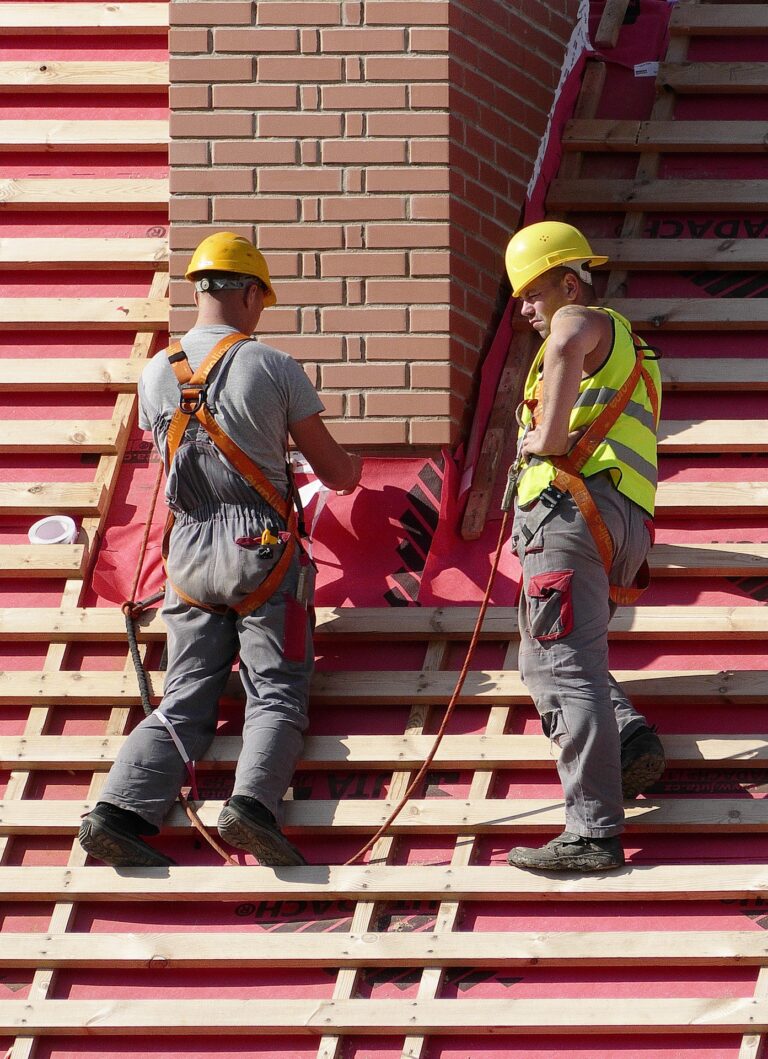 roofers in harness on rooftop