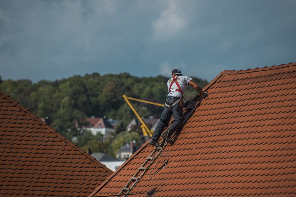 roofer on top of shingle roof